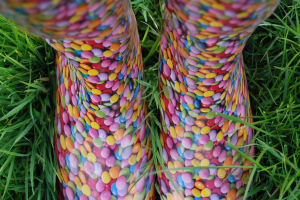 Verschiedene farbenfrohe Edelsteine sind auf einem grünen Rasen ausgebreitet.